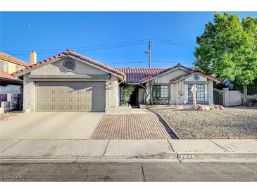 Charming single-story home with a well-maintained yard, desert landscaping, and a two-car garage at 6771 Shelter Ln, Las Vegas, NV 89103