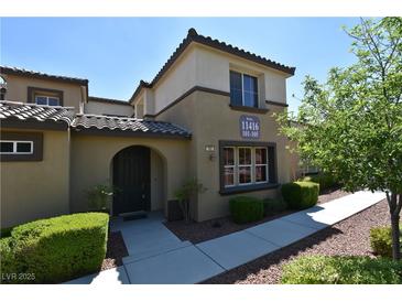 Inviting home featuring a well-maintained lawn, arched entryway and clearly displayed address number at 11416 Belmont Lake Dr # 102, Las Vegas, NV 89135