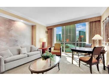 Bright living room features cityscape views, comfortable seating, and neutral decor at 145 E Harmon Ave # 409, Las Vegas, NV 89109