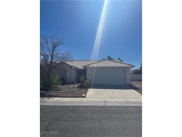 Charming single-story home featuring a well-maintained front yard, desert landscaping, and a two-car garage at 3912 Branchwood Dr, North Las Vegas, NV 89032