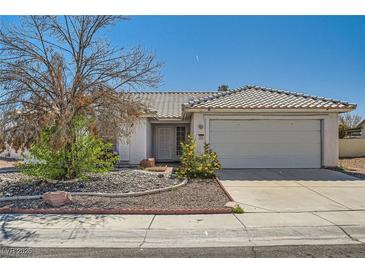 Single-story home featuring desert landscaping, a tile roof, and an attached two-car garage at 3912 Branchwood Dr, North Las Vegas, NV 89032