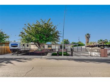 Charming single-story home with a mature shade tree, RV parking, and secure fencing at 4284 Parkdale Ave, Las Vegas, NV 89121