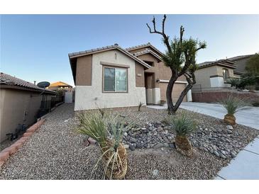 Charming single-story home with desert landscaping and neutral colored exterior at 5019 Quiet Falls Ct, Las Vegas, NV 89141