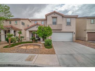 Charming two-story home featuring a well-manicured front yard and attached two-car garage at 5021 Apache Valley Ave, Las Vegas, NV 89131