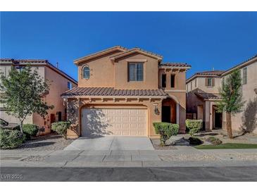 Charming two-story home with a tile roof, complemented by a well-manicured front yard and an attached two-car garage at 644 Mauna Kea Pl, Henderson, NV 89011