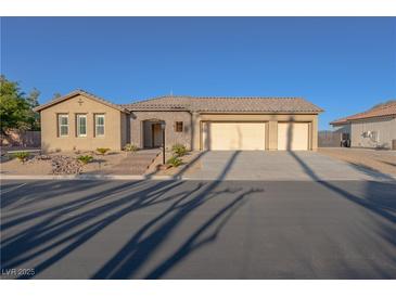 Charming single-story home featuring a three-car garage and low-maintenance desert landscaping at 8228 Fulton Ranch St, Las Vegas, NV 89131