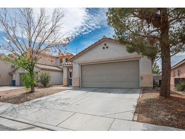 Charming home featuring a two-car garage and a well-maintained front yard at 9535 Golden Scots Ct, Las Vegas, NV 89123