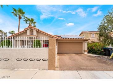 Charming single-story home featuring a well-manicured yard and a two-car garage at 988 Flapjack Dr, Henderson, NV 89014