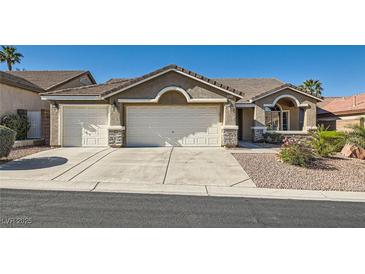 Charming single-story home featuring a three-car garage, well-maintained landscaping, and a tile roof at 10212 Donald Weese Ct, Las Vegas, NV 89129