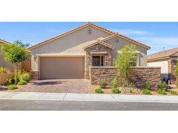 Charming single-story home with a two-car garage, stone accents, desert landscaping, and a brick driveway at 10972 Nicholas Jay Ave, Las Vegas, NV 89166