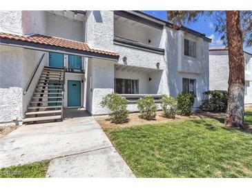 Condo exterior featuring stucco walls, a red tile roof, and well-maintained landscaping at 1455 E Katie Ave # D17, Las Vegas, NV 89119