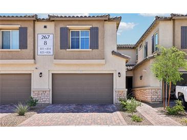 Inviting townhome featuring a two-car garage and desert landscaping at 267 Cordelia Cove Ave # 812, Henderson, NV 89011