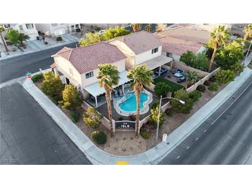 Gorgeous aerial view of a home with a pristine pool and well-manicured landscaping in a desirable neighborhood at 3194 Lapis Beach Dr, Las Vegas, NV 89117