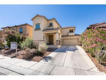 Charming two-story stucco home featuring a desert landscape, tile roof, and attached two-car garage at 3553 Terneza Ave, North Las Vegas, NV 89081