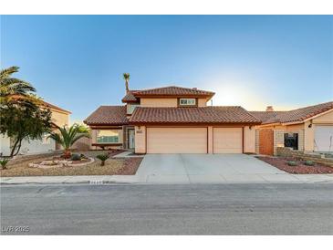 Charming two-story home featuring a three-car garage, tile roof, and desert landscaping in the front yard at 4835 Illustrious St, Las Vegas, NV 89147