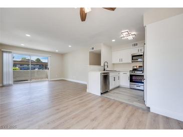 Bright living room blends seamlessly with the modern kitchen and stainless steel appliances at 5217 Caspian Springs Dr # 101, Las Vegas, NV 89120