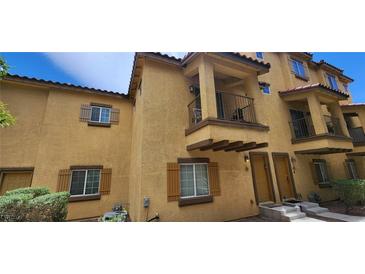 Charming townhome featuring a private balcony, desert landscaping, and a covered entry at 5915 Nuevo Leon St # 8, North Las Vegas, NV 89031