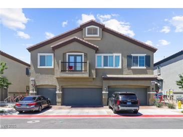 Charming townhouse with three garage doors and a small balcony at 7515 Emerald Stars St # 102, North Las Vegas, NV 89084