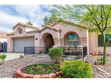 Charming single-story home with a well-maintained front yard and cozy porch seating area at 930 High Plains Dr, Henderson, NV 89002