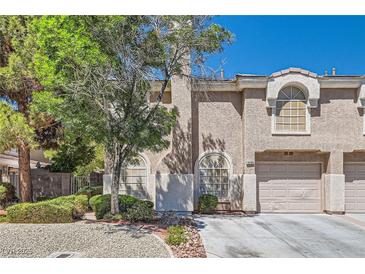 Charming two-story townhome featuring a well-maintained front yard and attached two-car garage at 10159 Tumbling Tree St, Las Vegas, NV 89183