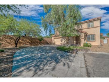 Charming two-story home featuring a spacious driveway and desert landscaping at 11273 Accademia Ct, Las Vegas, NV 89141