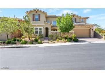 Charming stucco home with stone accents, a well-manicured landscape and a two-car garage at 12273 Catanzaro Ave, Las Vegas, NV 89138