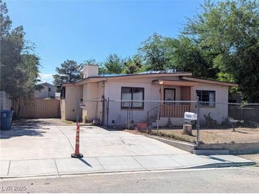 Exterior view of a single story home with a fenced yard and driveway at 1655 N Gateway Rd, Las Vegas, NV 89115