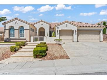 Charming single-story home featuring a three-car garage, mature landscaping, and a tile roof at 2868 Foxtail Creek Ave, Henderson, NV 89052