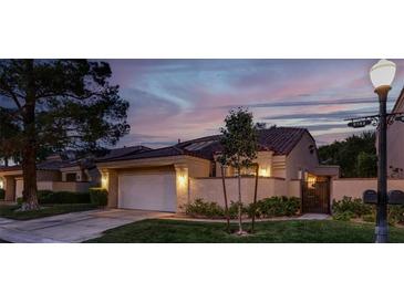 Charming single-story home with manicured lawn, attached garage, and beautiful evening sky at 5142 Southern Hills Ln, Las Vegas, NV 89113