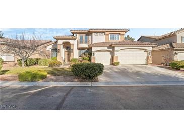 Charming two-story home with a well-manicured front yard and a three car attached garage at 5684 Benevento Ct, Las Vegas, NV 89141
