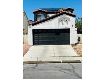 Charming two-story home featuring a spacious two-car garage and low maintenance desert landscaping at 6640 Crosstimber Ct, Las Vegas, NV 89108