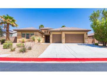 Inviting home with a three-car garage and desert landscaping for low maintenance in a sunny neighborhood at 7434 Eggshell Dr, North Las Vegas, NV 89084