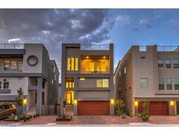 Modern three-story home showcasing a balcony, rooftop deck, and two-car garage with appealing landscaping at 8092 Haywood Estate Ave, Las Vegas, NV 89113