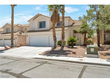 Charming two-story home featuring a three car garage and desert landscaping in a suburban neighborhood at 9923 Sierra Canyon Way, Las Vegas, NV 89147