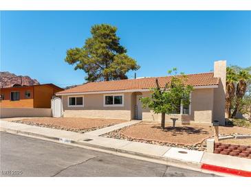 Charming single-story home features a red tile roof and well-manicured landscaping at 100 Walker Way, Boulder City, NV 89005