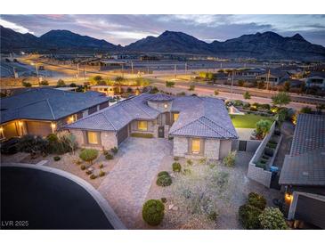 Stunning home featuring manicured landscaping and tile roofing set against a mountain backdrop at 12168 Dorada Coast Ave, Las Vegas, NV 89138