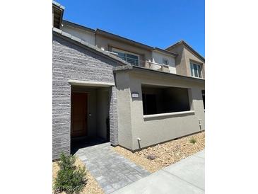 Modern townhome featuring a stylish stone facade and a covered entry at 2536 Vandra St, Las Vegas, NV 89138