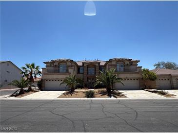 Stunning two-story home featuring a three-car garage and mature landscaping at 357 Whispering Tree Ave, Las Vegas, NV 89183