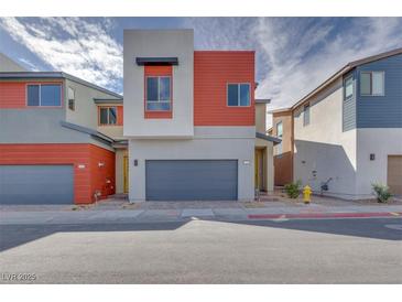 Charming two-story home with modern design, grey garage door, and red accent wall at 4349 Tabor Peak Ave, Las Vegas, NV 89141