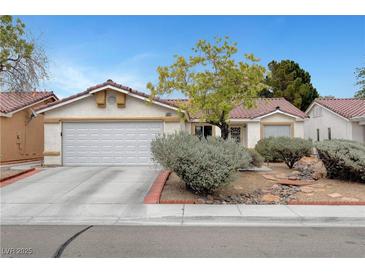 Charming single-story home with a well-maintained front yard and attached two car garage at 5220 Shasta Daisy St, North Las Vegas, NV 89031