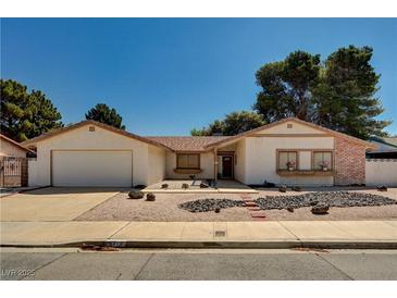 Charming single-story home with desert landscaping and a two-car garage on a sunny day at 5274 Somerset Dr, Las Vegas, NV 89120