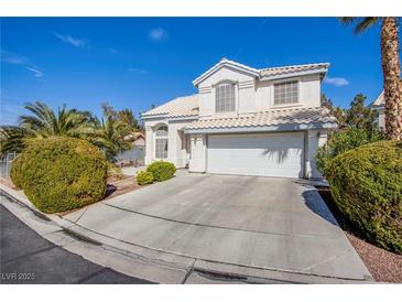Charming two-story home featuring a well-manicured lawn and a two-car garage in a sunny, suburban neighborhood at 6259 Santander Ave, Las Vegas, NV 89103