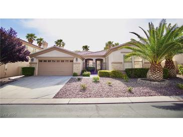 Charming single-story home with desert landscaping, mature palm trees, and a two-car garage at 66 Sunset Bay St, Las Vegas, NV 89148