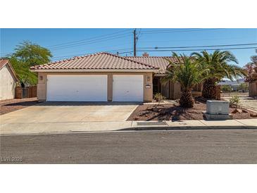 Charming home with desert landscaping, two-car garage, and red tile roof at 688 Arrowhead Canyon Dr, Henderson, NV 89002