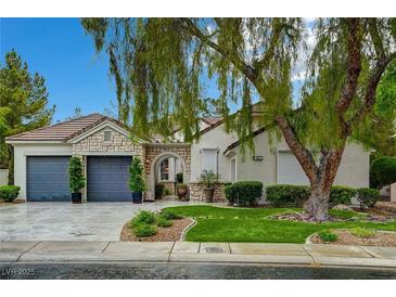 Charming single-story home featuring a stone facade, well-manicured lawn, and a three-car garage at 729 Sir James Bridge Way, Las Vegas, NV 89145