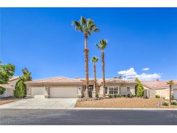 Charming single-story home featuring desert landscaping, palm trees and a two-car garage at 7410 Bridlehorne Ave, Las Vegas, NV 89131