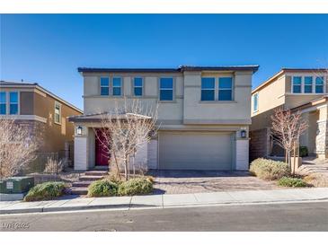 Two-story home featuring a two-car garage and landscaped front yard, all under a clear blue sky at 841 Riverlawn Pl, Las Vegas, NV 89138