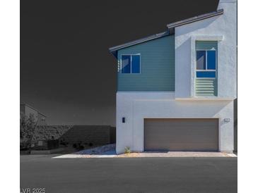 A modern two-story home featuring a neutral color scheme, a garage, and an inviting facade at 9756 Rock Cliff St, Las Vegas, NV 89141