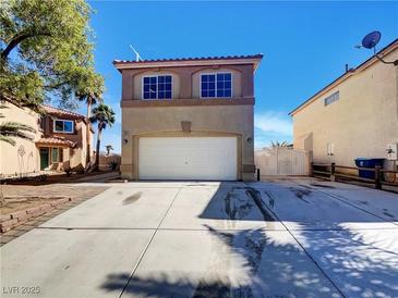 Charming home featuring a two-car garage, classic architectural details, and well-maintained landscaping at 983 Plantain Lily Ave, Las Vegas, NV 89183