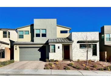 Two-story home featuring modern architecture, a two car garage and desert landscaping at 10280 Midnight Meteor Ave, Las Vegas, NV 89166